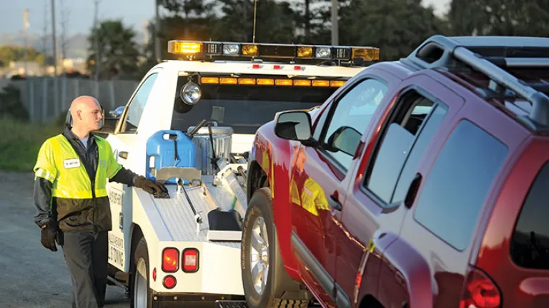 Tow Truck driver and truck with vehicle in tow