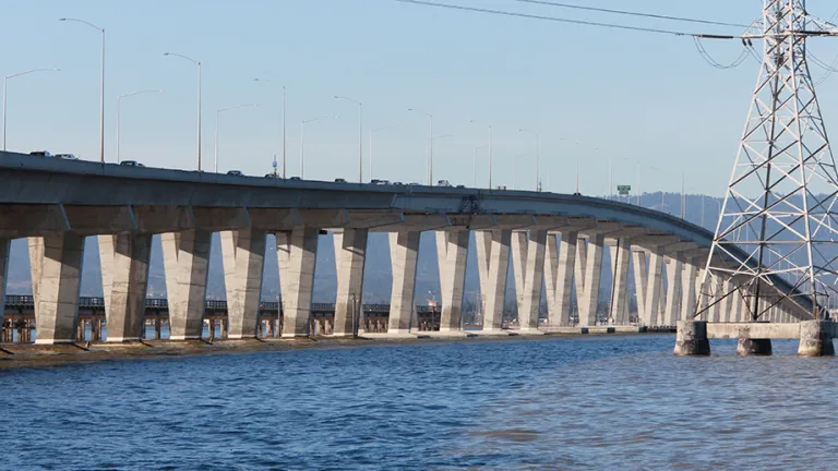 Low angle view of the Dumbarton Bridge over water.