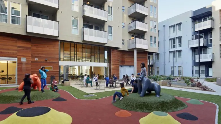 A group of kids playing in outdoor housing playground