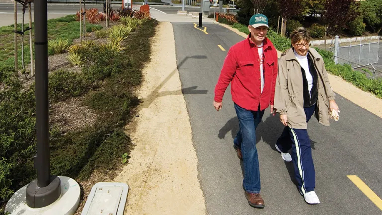Two adults walking on South San Franciso's Centennial Way, a separated path for walking and biking.