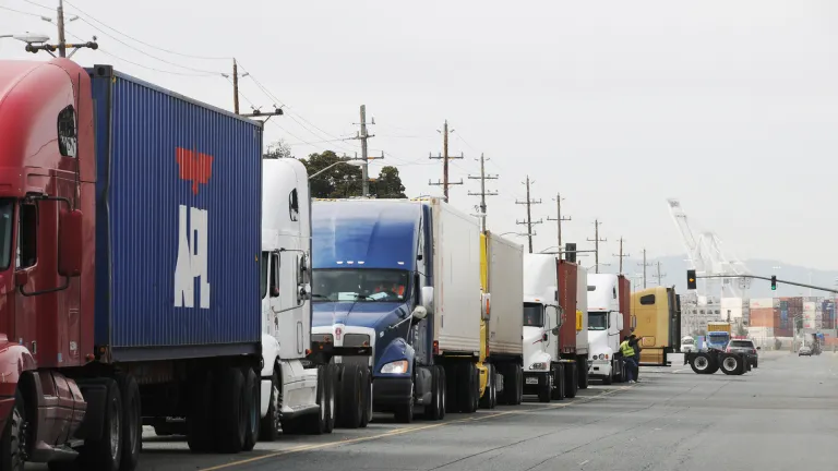 A long line of container trucks at the Port of Oakland.