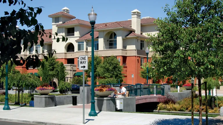 A man sits outdoors in the Bay Meadows Priority Development Area in San Mateo.