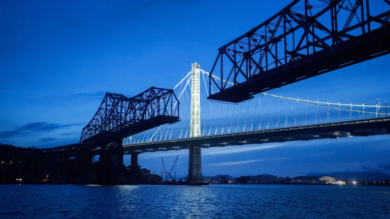 The Bay Bridge in background with dismantled San Francisco-Oakland Bay Bridge in foreground