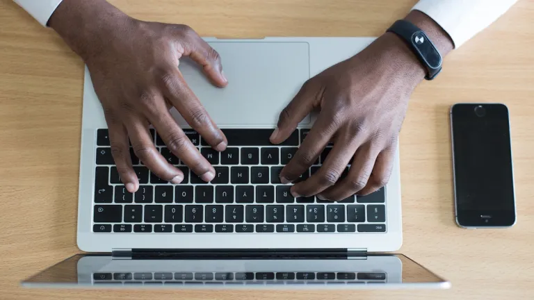 A person typing on a laptop.