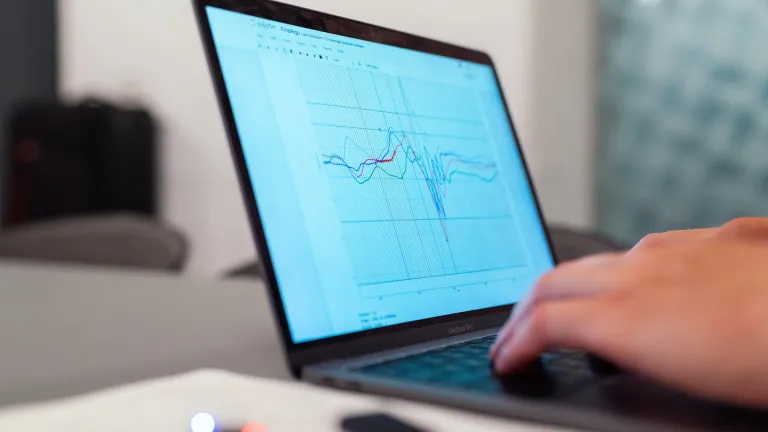 Laptop with a data graph on the screen.