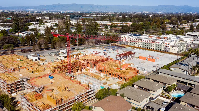 A large apartment building under construction in a residential neighborhood in the South Bay.
