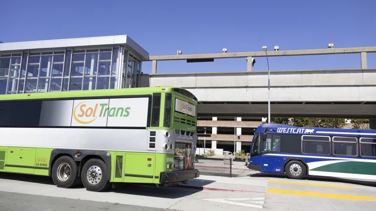 A SolTrans bus and a WestCAT bus at the El Cerrito del Norte BART station.