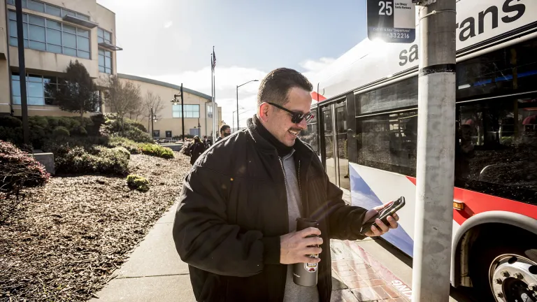 A passenger waiting to board a SamTrans bus.