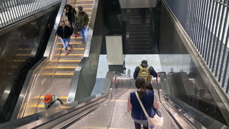 Transit travelers going up and down stairs at the Civic Center BART station in San Francisco.
