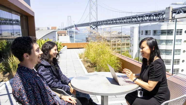 MTC staff meeting on the terrace at the Bay Area Metro Center, with a view of the Bay Bridge.
