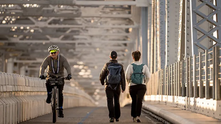 A cyclist and pedestrians on the Richmond-San Rafael bicycle/pedestrian path