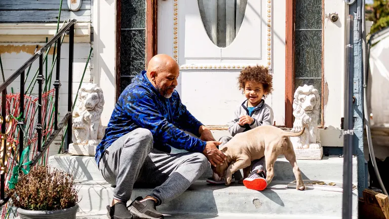 A happy family on the front steps of their home.