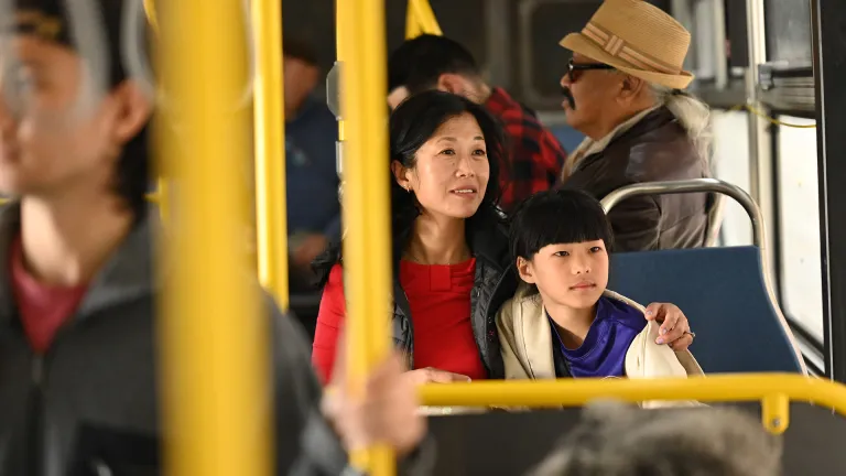 A mother and daughter riding a Muni bus.