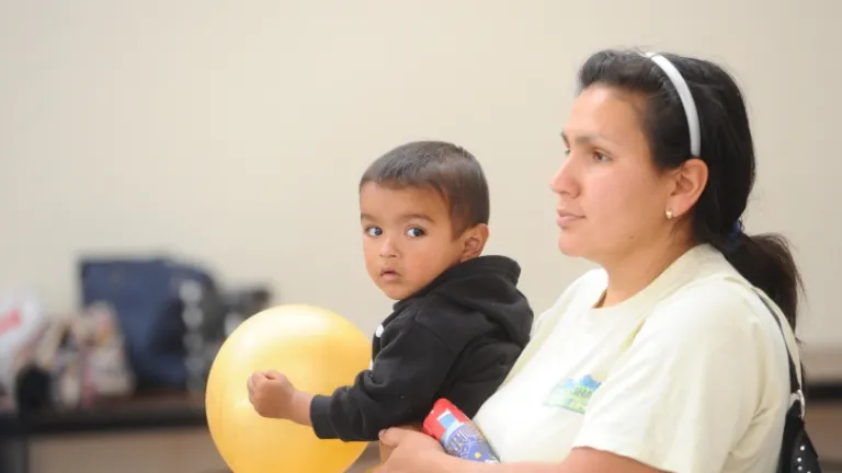 A member of the public with her child at an MTC meeting