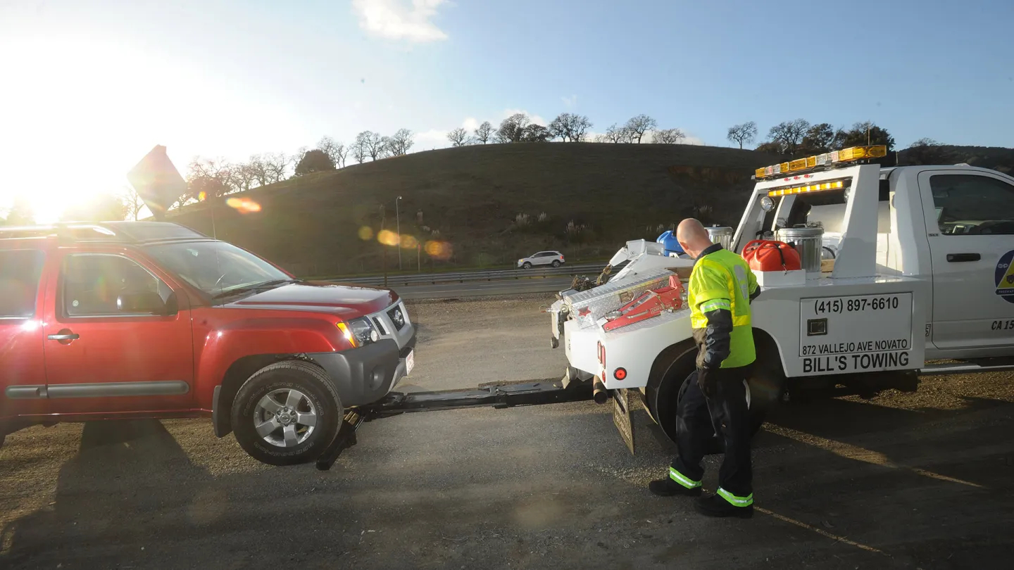 A Freeway Service Patrol tow truck assisting a motorist.