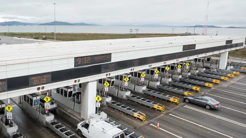 Aerial over the San Francisco-Oakland Bay Bridge Toll Plaza.