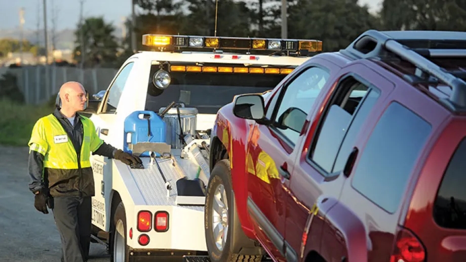Tow Truck driver and truck with vehicle in tow