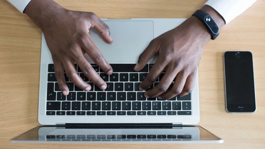 A person typing on a laptop.