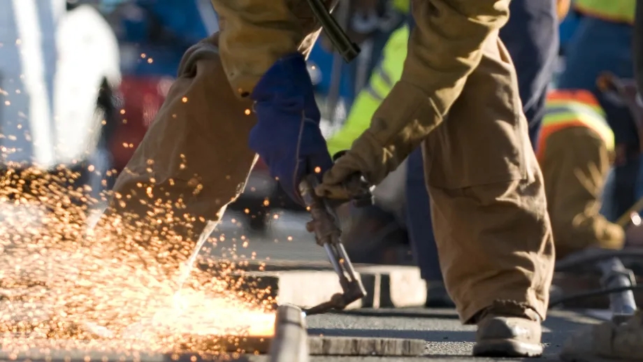 A welder repairing a segment of the San Francisco Bay Bridge.