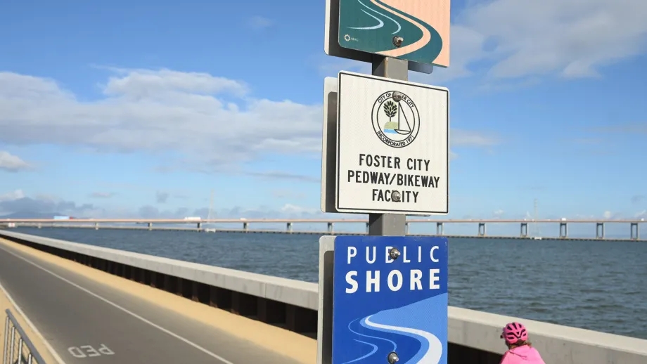 A cyclist rides on the separated path at the Foster City shoreline levee.