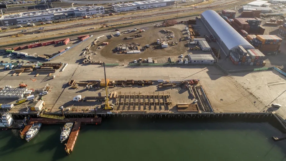 Aerial over an industrial area next to a body of water.