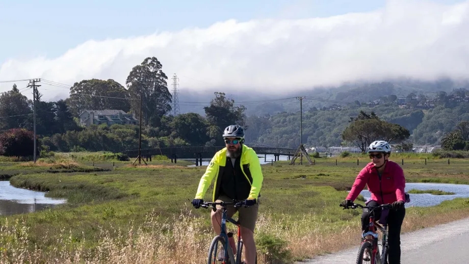 Cyclists ride through a marsh trail in Marin County.
