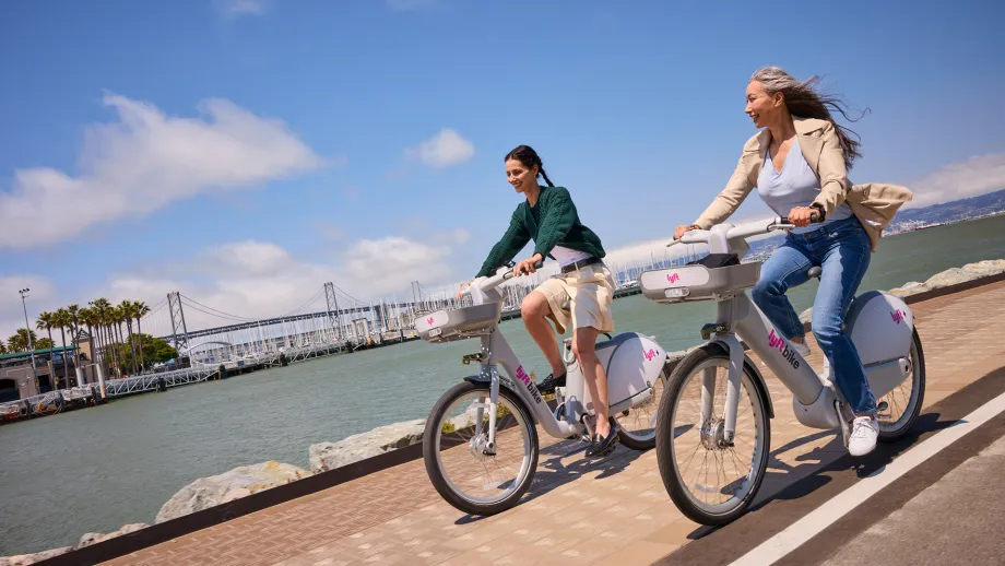 Two people riding Lyft Bikes in San Francisco.
