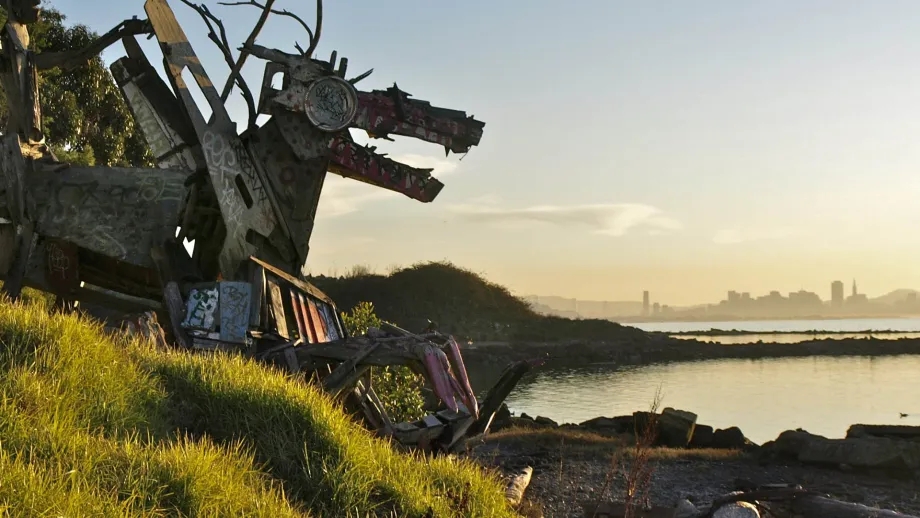 A dragon sculpture at the Albany Bulb, with the San Francisco skyline in the background.